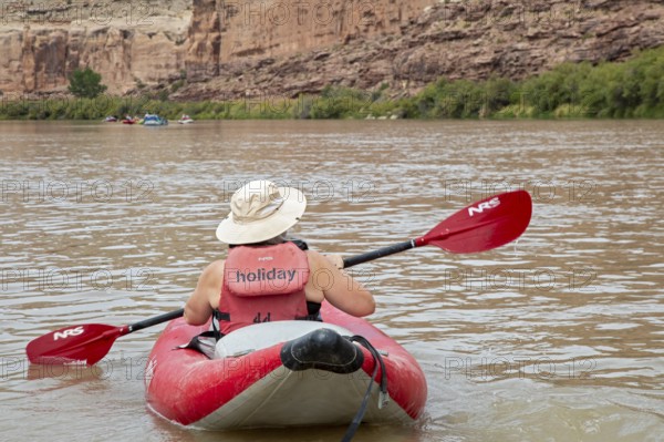 Loma, Colorado - A woman paddles an inflatable kayak, part of a river rafting trip on the Colorado River's Ruby Canyon and Westwater Canyon. The trip was run by Holiday River Expeditions