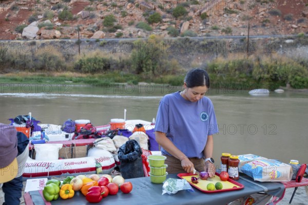 Loma, Colorado - A river guide prepares a meal during a rafting trip through the Colorado River's Ruby Canyon and Westwater Canyon. The trip was run by Holiday River Expeditions