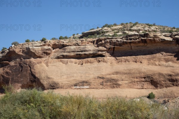 Loma, Colorado - Letters carved into the rock above the Colorado River mark the boundary between the states of Colorado and Utah