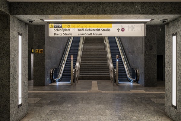 Escalators and signposts at the Museumsinsel subway exit in Berlin Mitte, Germany
