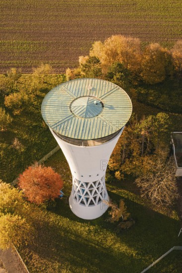 Aerial view of a water tower surrounded by colorful autumn leaves and fields, Möglingen water tower, Germany