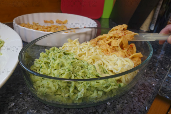 Swabian cuisine, preparation of hand-scraped spaetzle, spaetzle casserole, three types of spaetzle, classic spaetzle, with spinach and red pepper, pastry, typical Swabian, from the oven, casserole dish, traditional cuisine, vegetarian, food photography, studio, Germany