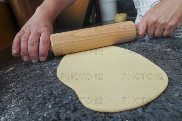 Swabian cuisine, preparing strudel dough, raw potato dough, rolling pin, countertop, baking, out of the oven, dough roll, men's hands, typical Swabian, traditional cuisine, food photography, studio, Germany