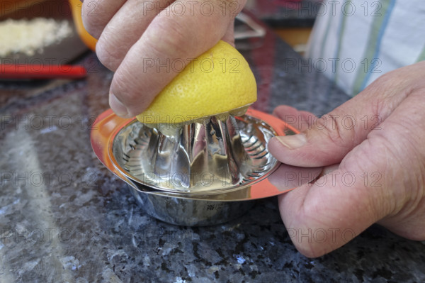 Southern German cuisine, preparation of aioli, garlic cream, mayonnaise, lemon squeezer, studio, food photography, men's hands, Germany