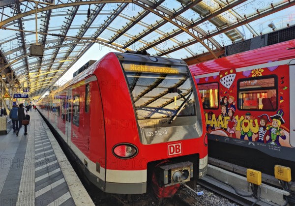 Central Station early in the morning with regional express and S-Bahn with carnival design, Cologne, Rhineland, North Rhine-Westphalia, Germany