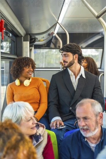 Diverse group of bus passengers traveling together, including a young african american woman wearing headphones talking with a man, and senior adults seated in the foreground