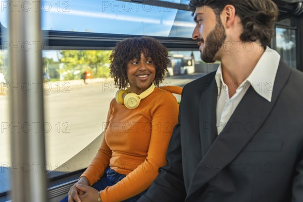 Couple chatting and smiling on a city bus, relaxed commuters sharing a warm, candid moment during their urban commute as daylight streams through the window