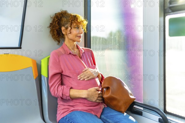 Pregnant woman sitting on a public bus, holding her belly, and looking out the window while contemplating her journey and the future, depicting motherhood and urban transit