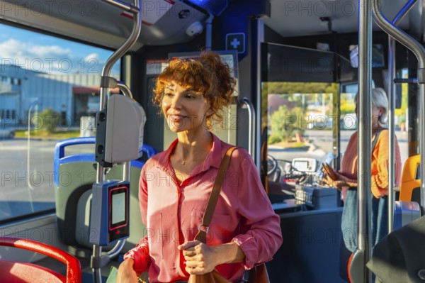 Smiling redhead woman validating a smart ticket on a modern city bus, preparing for her daily commute urban transit moment showing convenient electronic ticketing and travel routine
