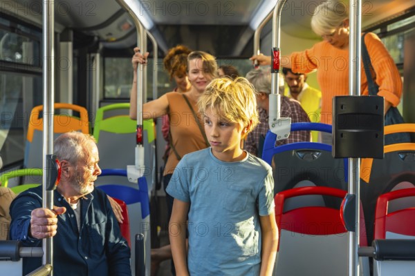 Young boy standing in a bus while other diverse passengers are commuting, experiencing urban public transport during daily life travel, showing people of different ages in motion