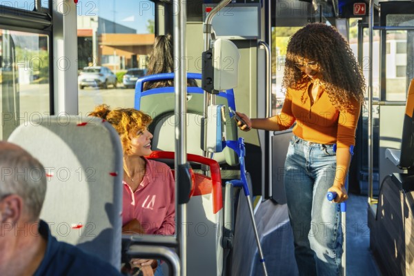 Young woman with crutches using contactless payment with smartphone to buy a ticket on public transport, showing independent mobility and modern urban life