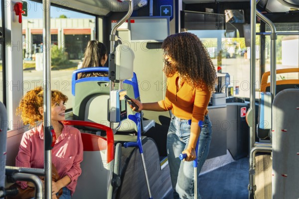 Woman with crutches paying for public transportation using smartphone at the ticket validator, emphasizing accessibility and modern payment solutions for commuters