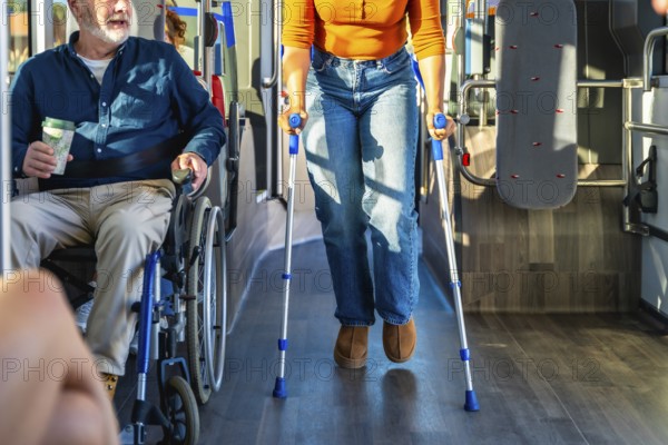 Senior man in wheelchair and woman with crutches navigate a busy city bus aisle together, illustrating accessible public transport, mobility, independence and inclusive commuting