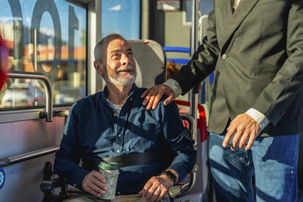 Young caregiver places hand on shoulder of smiling senior man in wheelchair during accessible public transport ride, sharing warmth, trust and comfortable mobility