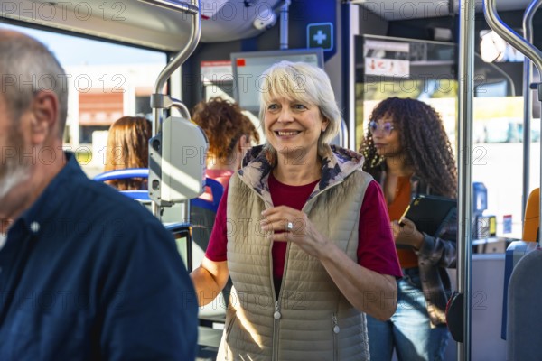 Senior woman smiling confidently, standing on a bustling urban bus alongside other passengers, enjoying her journey and connecting with public transport for daily commuting