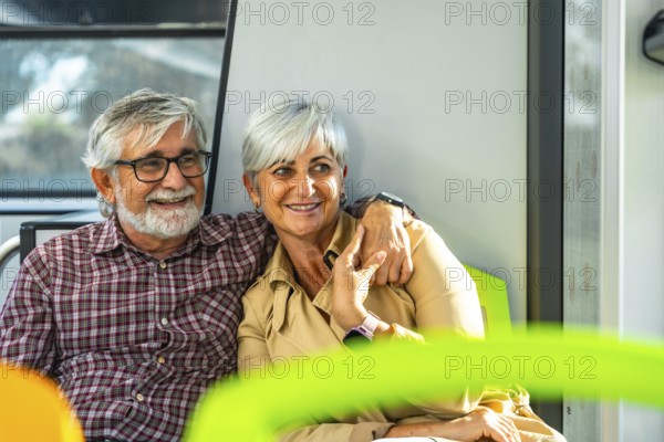 Senior couple embraces on a city bus, smiling and enjoying retirement travel together, warm companionship and cheerful moments as they sit side by side during their journey