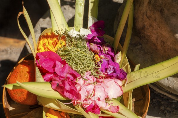 Canang Sari is a Balinese offering that expresses Wasa (God) or the creators of life to Sang Hyang Widhi. The offerings are used to balance and maintain peace on earth, between good and evil, between gods and demons, between heaven and hell, Kuta beach, Bali, Indonesia