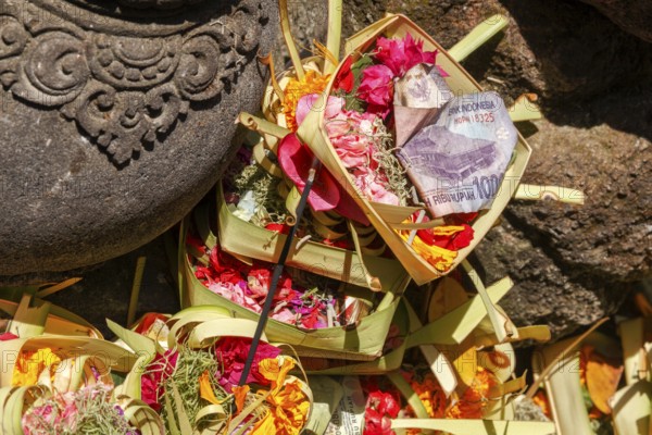 Sacrificial basket (canang) at Tirta Empul hot springs, Bali, Indonesia