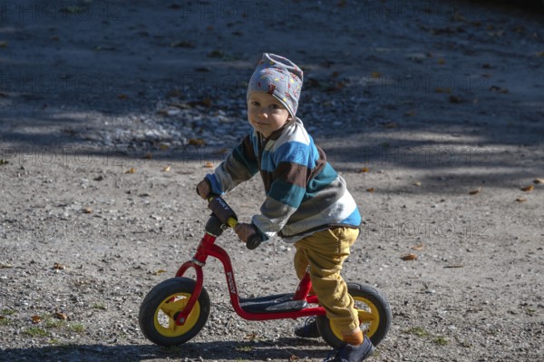 Little boy, two years old, with his bicycle, Othenstorf, Mecklenburg-Western Pomerania, Germany