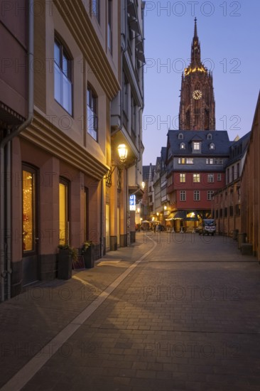 The lights in the shops of Frankfurt's New Old Town and the top of St. Bartholomew's Cathedral glow in the evening, New Old Town, Frankfurt am Main, Hesse, Germany