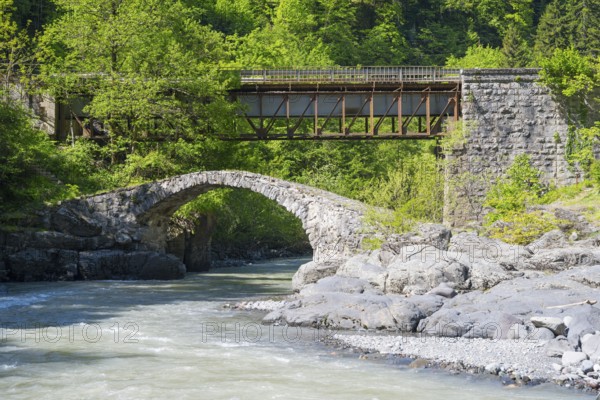 Stone and car bridge crossing a river in a mountainous forest landscape, Purtio stone arch bridge, Adjaristskali river, Adjara, Adjaria, Lesser Caucasus, Georgia