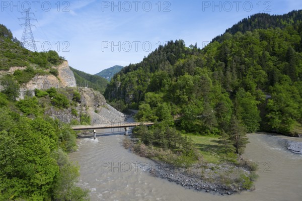 A wide river flows under a bridge through wooded hills while a power line crosses the rocky landscape, landscape near Kldisubani, Adjaristskali River, Adjara, Adjaria, Lesser Caucasus, Georgia