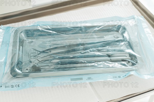 Sterile medical instruments, lying on a tray in protective packaging, dentist's instruments, preparation for a medical procedure
