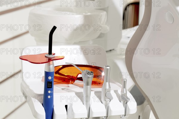 Dental instruments, photopolymer lamp, safety glasses, on a modular table