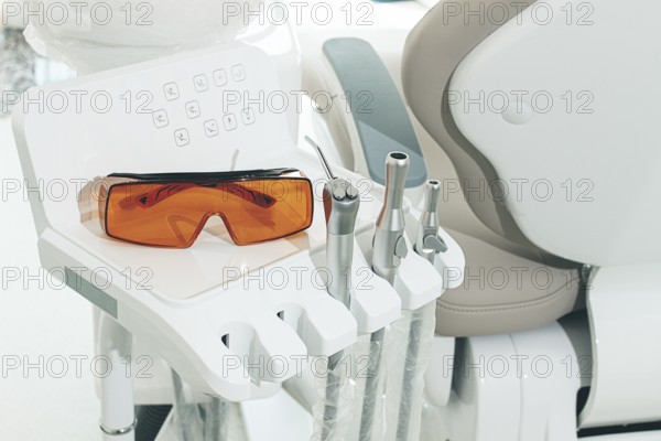 Dental instruments and safety glasses on the module, there are no people in the dental clinic