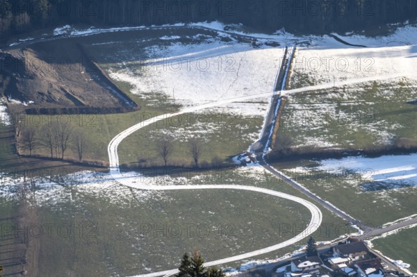 Snow-covered trail between green meadows, Brixental, Tyrol, Austria