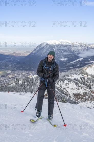 Happy ski tourer climbing to Längenfelderkopf, in winter, Wetterstein Mountains, Garmisch-Partenkirchen, Bavaria, Germany