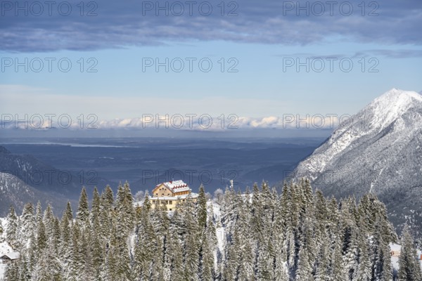 Snowy forest and Kreuzeckhaus mountain hut in the Garmisch Classic ski area in winter, Wetterstein Mountains, Garmisch-Partenkirchen, Bavaria, Germany