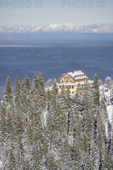 Snowy forest and Kreuzeckhaus mountain hut in the Garmisch Classic ski area in winter, Wetterstein Mountains, Garmisch-Partenkirchen, Bavaria, Germany