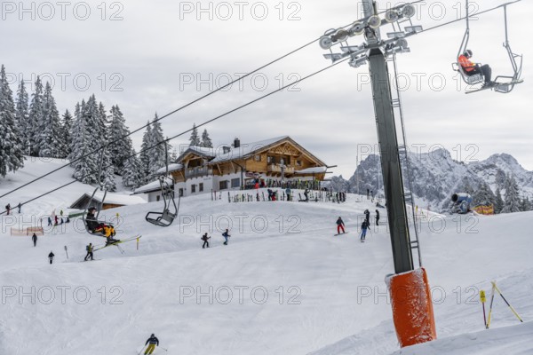 Kreuzeckbahn ski lift and ski hut Kreuzalm, skiers in the Garmisch Classic ski area in winter, Wetterstein Mountains, Garmisch-Partenkirchen, Bavaria, Germany