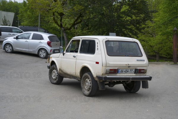 White Lada on a rural road in a green area, Imereti region, Imereti, Georgia