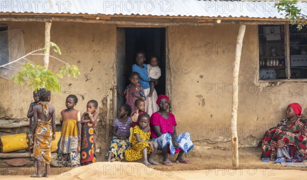 African woman and children in the house entrance, in a Sadaani village, Tanga, Tanzania