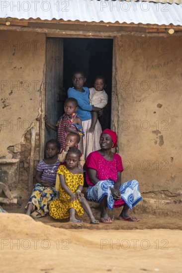 African woman and children in the house entrance, in a Sadaani village, Tanga, Tanzania