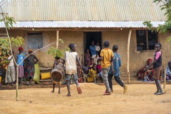 Residents in the main house of a village, children with drums, in a Sadaani village, Tanga, Tanzania