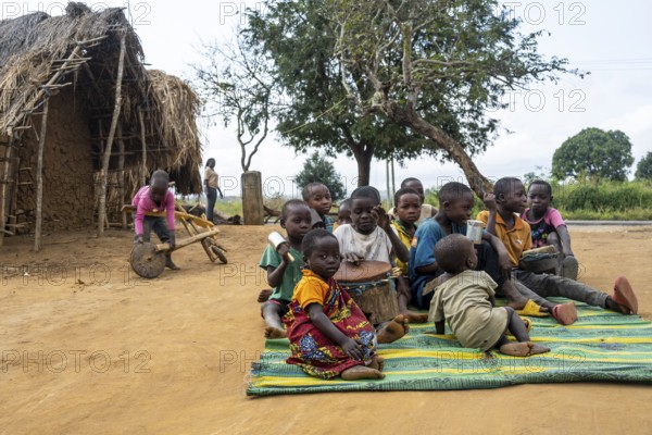 Group of African children playing music with drums in a Sadaani village, Tanga, Tanzania