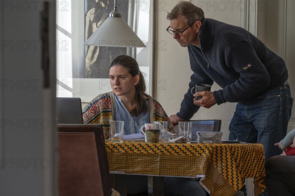 Home office, father and daughter working at breakfast table, Mecklenburg-Vorpommern, Germany