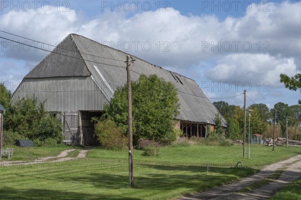 Old barn from 1921, formerly thatched, covered with asbestos panels in GDR times 1970s, Othenstorf, Mecklenburg-Western Pomerania, Germany