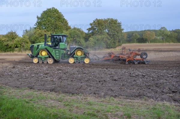Crawler tractors harrow the field, Othenstorf, Mecklenburg-Western Pomerania, Germany
