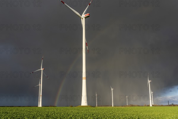 Königshovener Höhe onshore wind farm, on the A44 motorway near Bedburg, in front of the Jackerath triangle, autumn, rainbow, dark rain clouds, recultivated open-cast mining area, Garzweiler open-cast lignite mine, operated by RWE and the city of Bedburg, North Rhine-Westphalia, Germany