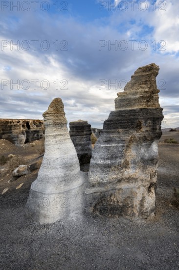 Eroded rock formations, volcanic landscape with dramatic cloudy skies, Ciudad Estratificada or Los Roferos, Antigua Rofera de Teseguite, Lanzarote, Canary Islands, Spain