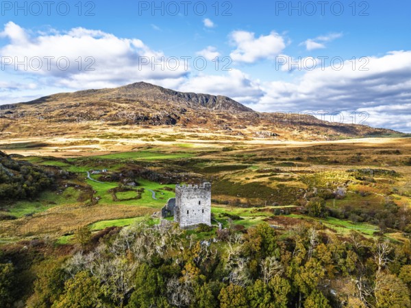 Autumn colours over Castell Dolwyddelan and Eryri Mountains from a drone, Snowdonia, Conwy County Borough, Wales, England, United Kingdom