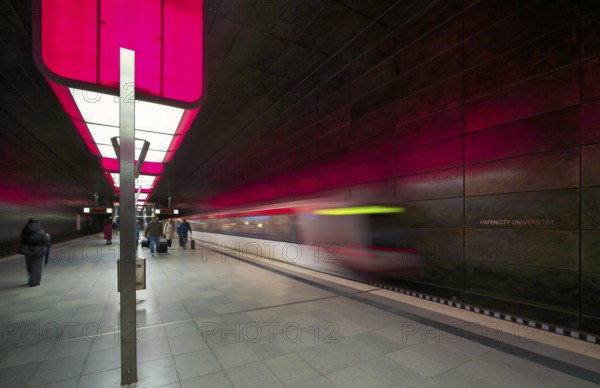 HafenCity University underground station, illuminated in color, magenta, underground train, movement effect, U4, travelers, platform, stop, train station, subway, public transport, HVV, Hamburger Verkehrsverbund, Hochbahn, public transport, Free and Hanseatic City of Hamburg, Germany