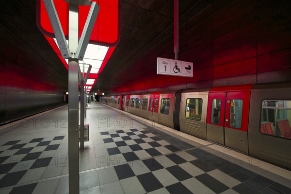 HafenCity University underground station, illuminated in color, green, underground train, U4, platform, stop, empty, train station, subway, sign, wheelchair access area, stroller, public transport, HVV, Hamburger Verkehrsverbund, Hochbahn, public transport, Free and Hanseatic City of Hamburg, Germany