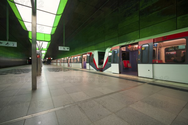 HafenCity University underground station, illuminated in color, green, underground train, U4, empty, platform, stop, train station, subway, sign, wheelchair access area, stroller, public transport, HVV, Hamburger Verkehrsverbund, Hochbahn, public transport, Free and Hanseatic City of Hamburg, Germany