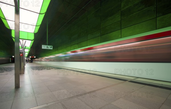 HafenCity University underground station, illuminated in color, green, underground train, movement effect, U4, empty, platform, stop, train station, subway, sign, boarding area wheelchair user, stroller, public transport, HVV, Hamburger Verkehrsverbund, Hochbahn, public transport, Free and Hanseatic City of Hamburg, Germany