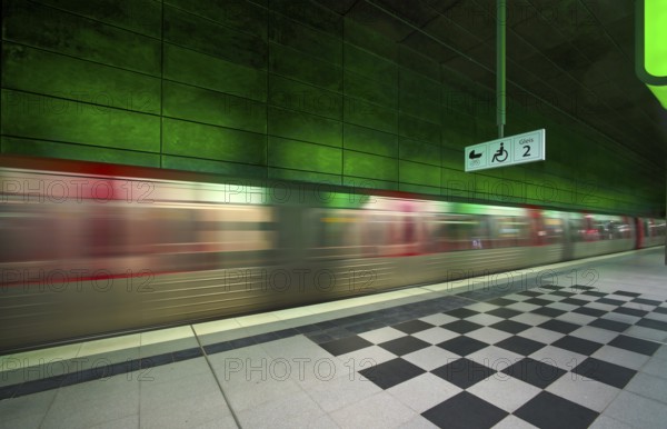 HafenCity University underground station, illuminated in color, green, underground train, movement effect, U4, platform, stop, train station, subway, sign, boarding area wheelchair user, stroller, public transport, HVV, Hamburger Verkehrsverbund, public transport, Freie und Hanseatic City of Hamburg, Germany